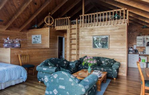 a living room with two couches and a table in a cabin at The Grange Lodge in Napier