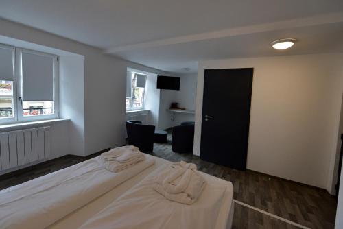a hotel room with two beds and a window at Gîtes Au Château Fleuri in Eguisheim