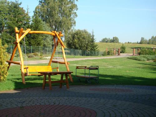 a playground with a bench and a swing at Agroturystyka Düsselkamp Tumiany in Barczewo