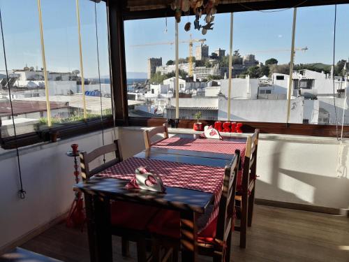 a table and chairs in a room with a large window at Mia Butik Hotel Bodrum in Bodrum City