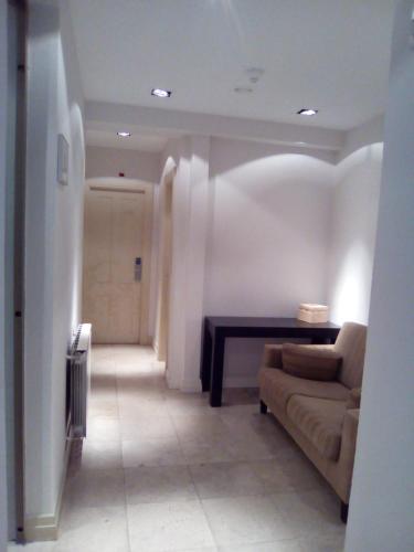 a living room with a couch and a table at Hotel Cuéntame La Puebla in Burgos