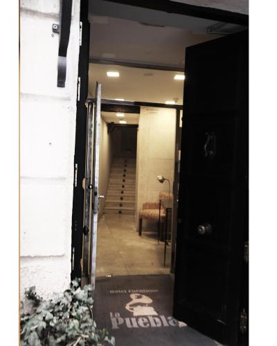 an open door to a hallway with a stairway at Hotel Cuéntame La Puebla in Burgos