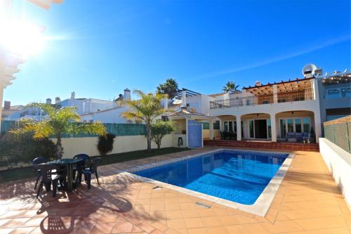 a villa with a swimming pool and a house at Villa Heloise 139 - Clever Details in Vilamoura