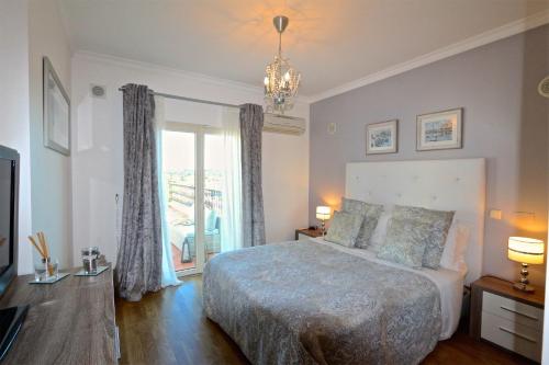 a bedroom with a bed and a large window at Villa Heloise 139 - Clever Details in Vilamoura