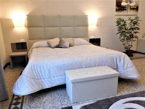 a bedroom with a large bed with a large headboard at Hotel Etnea Royal Suites in Catania