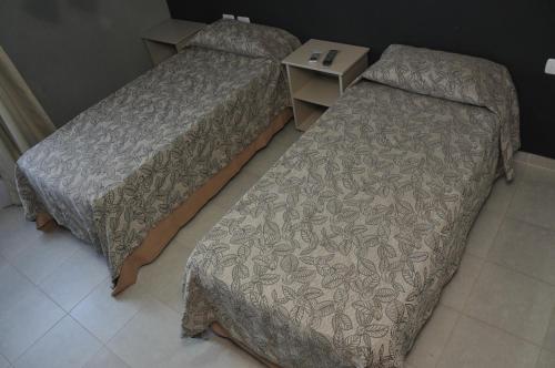 a bedroom with two beds and a night stand at Club Valle Termal Resort in Federación