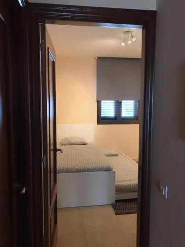 a bedroom with two beds and a mirror at Casa Natalie in El Cotillo