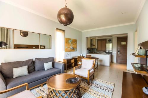 a living room with a couch and a table at Avani Pemba Beach Hotel in Pemba