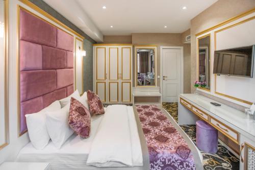 Ένα ή περισσότερα κρεβάτια σε δωμάτιο στο Gold Tbilisi Hotel