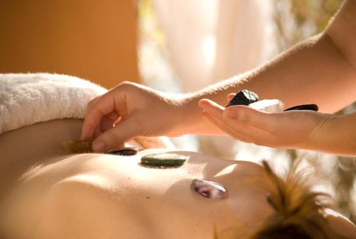 a woman in a bathtub getting a spa treatment at Avani Pemba Beach Hotel in Pemba
