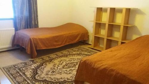 a room with two beds and a rug at Nice spacious home in Vaasa