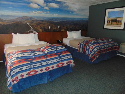a hotel room with two beds and a painting on the wall at Bryce Canyon Resort in Bryce Canyon