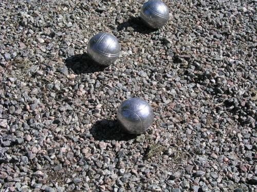 three metal balls sitting on the ground at Haga Slott in Enköping