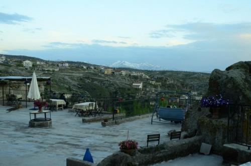 a patio with a view of a mountain at Kapadokya Ihlara Konakları Otel Konak Odaları in Guzelyurt