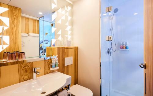 a bathroom with a sink and a shower at Alt Hotel St. John's in St. John's