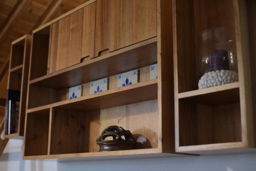 a wooden cabinet with a bunch of shelves at Canário do Mar - Rural Tourism in Angra do Heroísmo