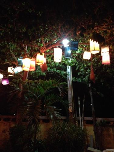 a street light with lights on it at night at Milin Guesthouse in Chiang Rai