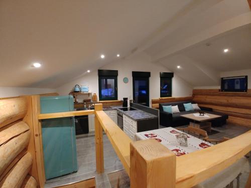 a large room with a kitchen and a living room at Ferienwohnungen Blockhaus - Zwergenhäusl Grünau im Almtal in Grünau im Almtal
