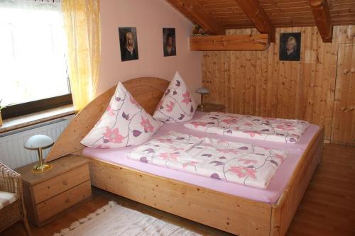 a bedroom with a large wooden bed in a room at Haus Koblizek in Waldkirchen