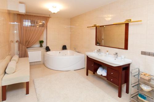 a bathroom with a tub and a sink and a mirror at Hotel Russia in Tiraspol