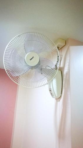 a fan on the ceiling of a room at Walking Street Residence - Boutique Suites near the Beach & Walking Street in Pattaya South