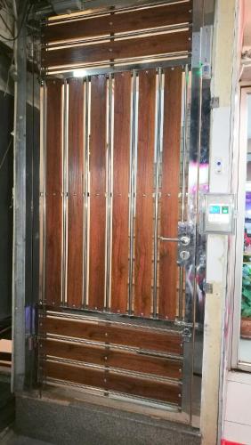 a glass door with wooden panels on a wall at Walking Street Residence - Boutique Suites near the Beach & Walking Street in Pattaya South