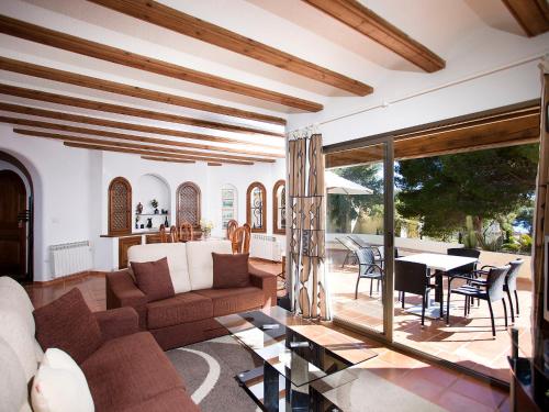 a living room with a couch and a table at Holiday Home Luz y Paz by Interhome in Altea la Vieja