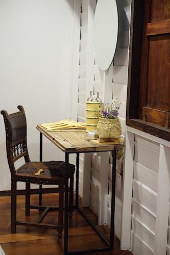 a table and a chair with a cake on it at The Good Days in Udon Thani