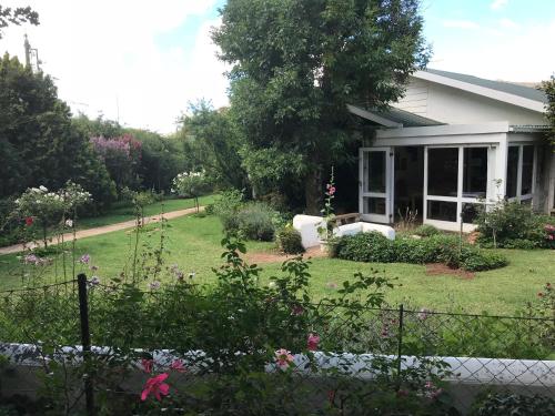 a house with a garden in front of it at Rosewood Corner, Clarens in Clarens