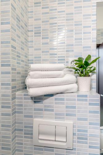 a stack of towels on a shelf in a bathroom at ConceptHT Regim Hotelier in Iaşi