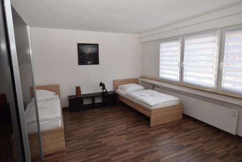 a room with two beds and a window at Apartment Gablenberg in Stuttgart