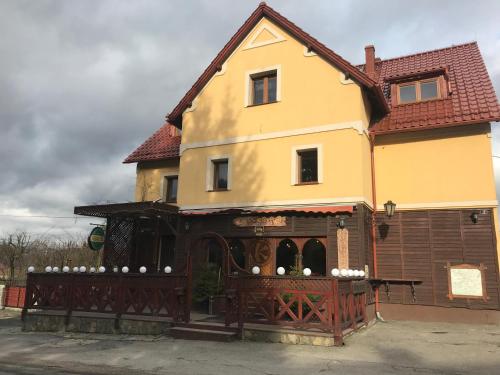 a house with a wooden fence in front of it at Podgórzanka in Kaczorów