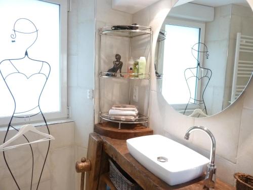 a bathroom with a sink and a mirror at La Berlue Bayeux in Saint-Vigor-le-Grand