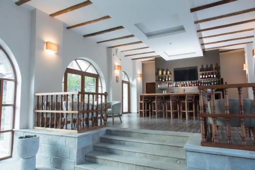 a room with stairs and a bar with wine bottles at Del Pilar Ollantaytambo in Ollantaytambo