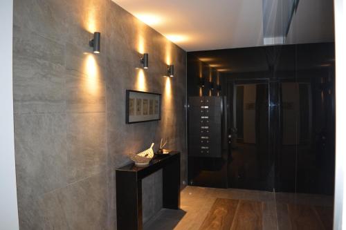 a hallway with a fireplace and a wall with lights at P.L Hermes Studios & Apartments in Larnaka