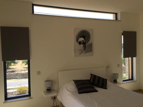 サン・ブラース・デ・アルポルテルにあるCasa De Estrelasのベッドルーム1室(ベッド1台、窓2つ付)