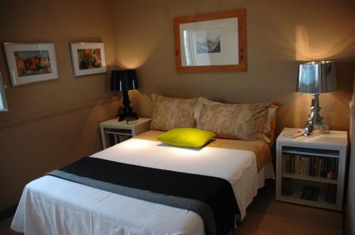 a bedroom with a bed with a yellow pillow on it at Penthouseinrome in Rome