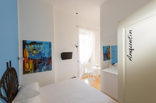a white bedroom with a white bed and a window at Bergamo Sottosopra in Bergamo