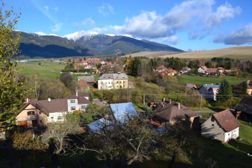 a village with houses and mountains in the background at Apartmán " Matej" in Smrečany