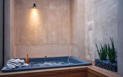 a bathroom with a blue tub with a plant at Monastery Estate Venetian Harbor in Chania Town