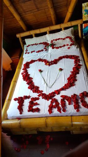 a bed with a heart made out of red roses at Hospedaje Rural Tupinamba in Ibagué