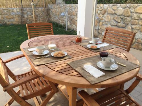 a wooden table with plates of food on it at Villetta Marina in Marciana Marina