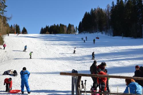 a group of people skiing down a snow covered slope at Apartmán " Matej" in Smrečany