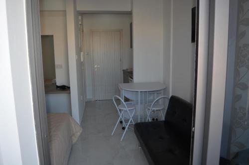 a small table and chairs in a small room at P.L Hermes Studios & Apartments in Larnaka