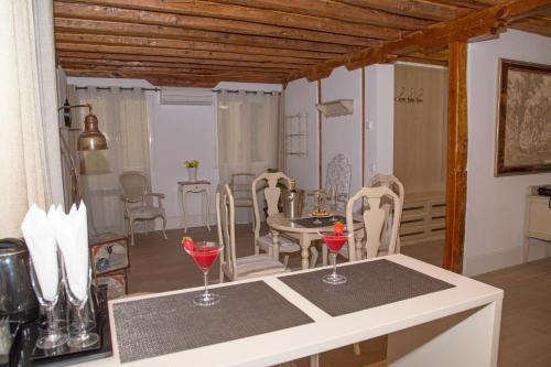 a kitchen and dining room with a table and chairs at Oriente Palace Apartments in Madrid