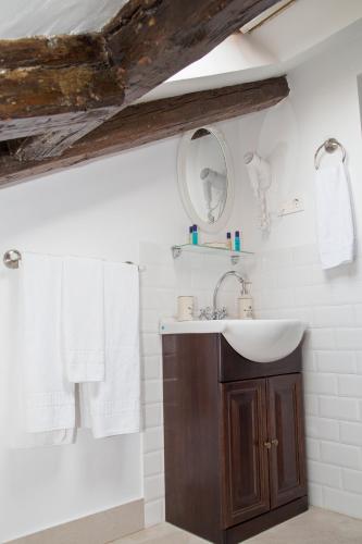 a bathroom with a sink and a mirror at Oriente Palace Apartments in Madrid