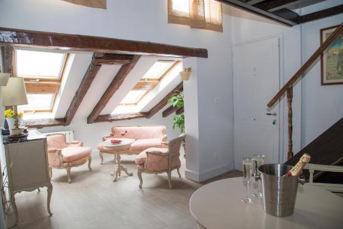 a living room with skylights and a table and chairs at Oriente Palace Apartments in Madrid