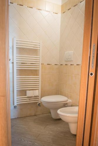 a bathroom with a toilet and a sink at Hotel Mirage in Torre Santa Sabina