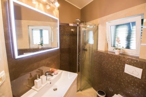 a bathroom with a shower and a sink at Incantesimo luxury penthouse in Mimice