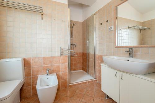 a bathroom with a sink and a toilet and a shower at Apartments Athos in Rabac
